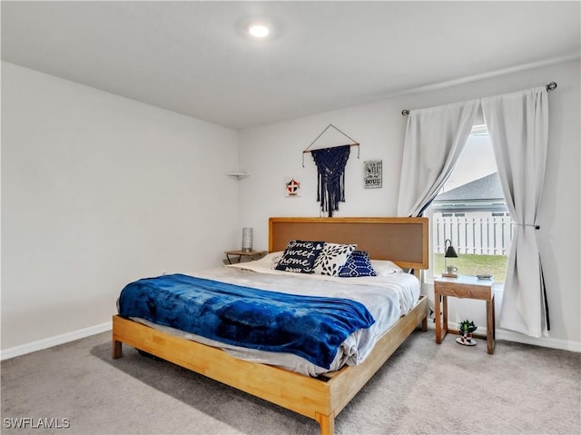 carpeted bedroom with baseboards