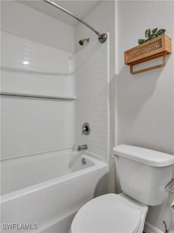 bathroom featuring shower / bath combination and toilet