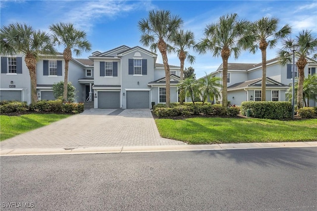 view of front of property with a garage and a front lawn