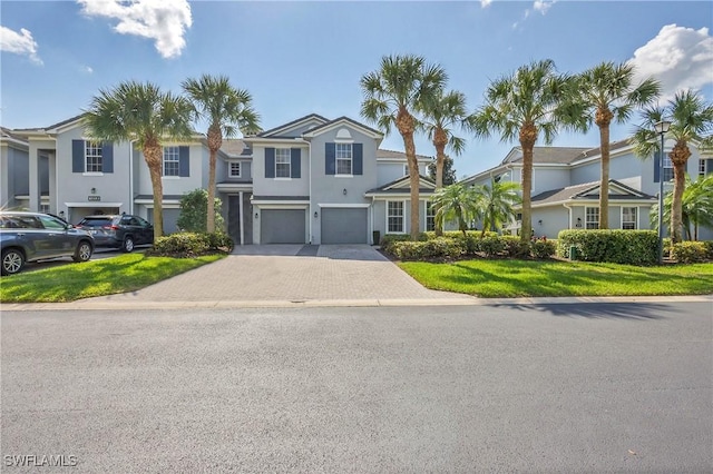 view of front of home featuring a garage and a front yard