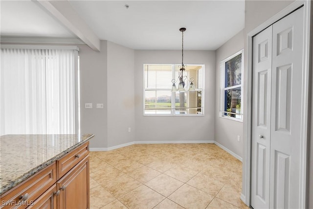 unfurnished dining area featuring light tile patterned floors, a notable chandelier, and beamed ceiling