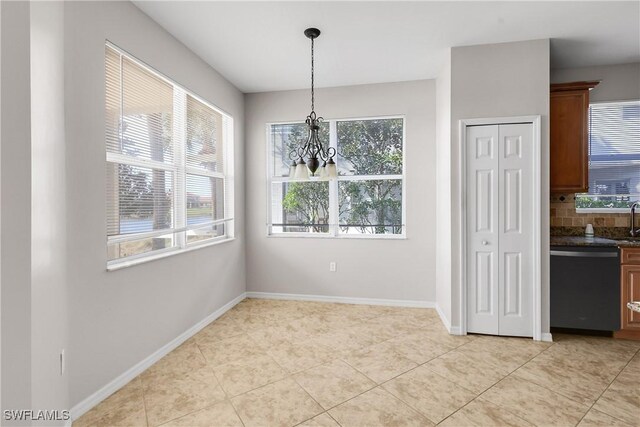 unfurnished dining area with light tile patterned floors and a notable chandelier