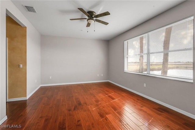 spare room featuring dark wood-type flooring and ceiling fan