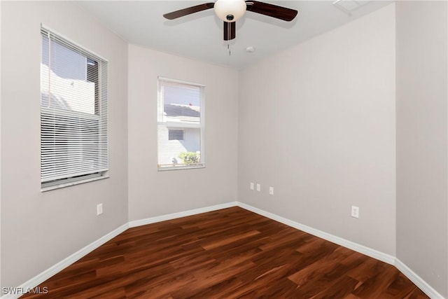 spare room featuring ceiling fan and dark hardwood / wood-style flooring