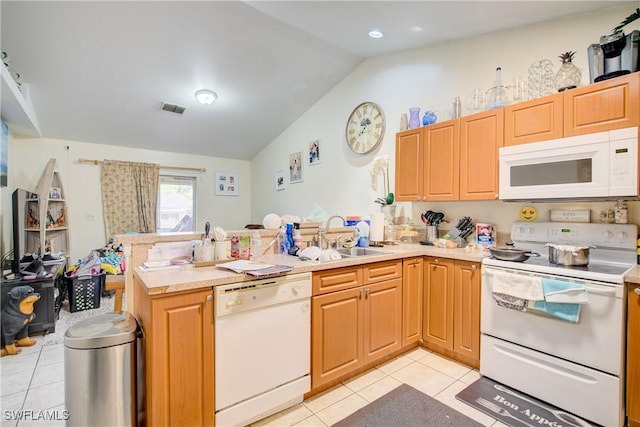 kitchen featuring lofted ceiling, sink, light tile patterned floors, kitchen peninsula, and white appliances