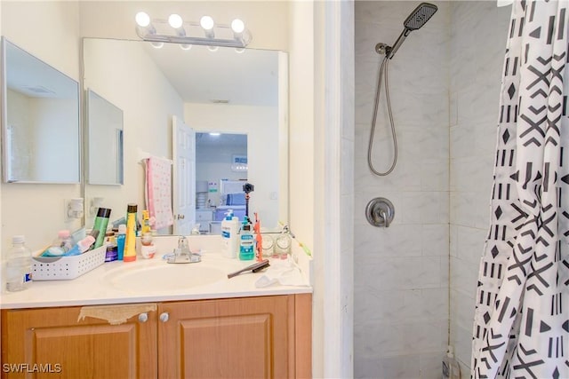 bathroom featuring vanity and curtained shower