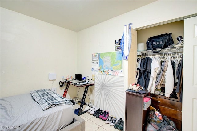 tiled bedroom featuring a closet