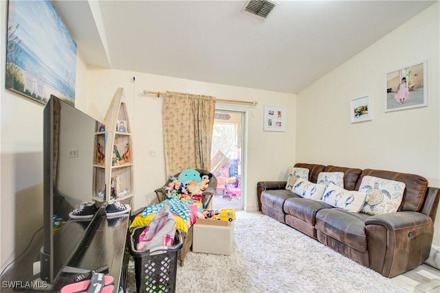 living room featuring vaulted ceiling