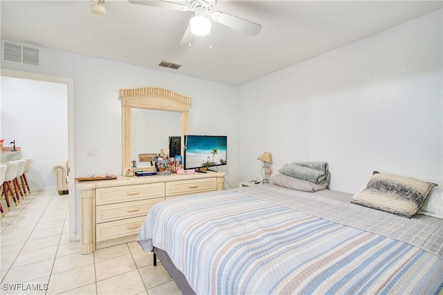 tiled bedroom featuring ceiling fan