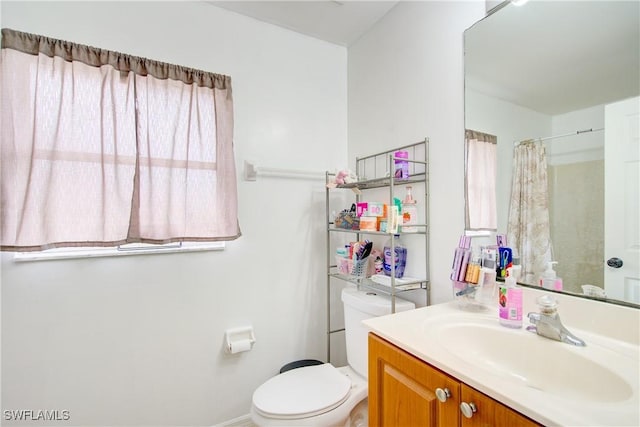 bathroom with vanity, toilet, and a shower with shower curtain