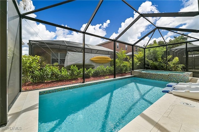 view of pool featuring an in ground hot tub, a lanai, and a patio