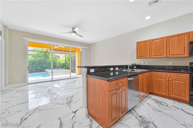 kitchen featuring sink, dishwasher, ceiling fan, kitchen peninsula, and dark stone counters