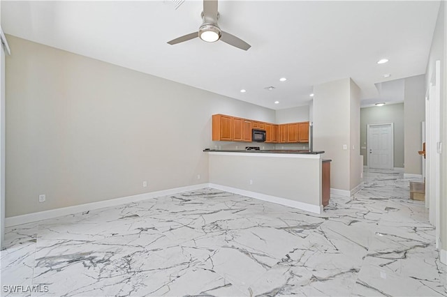 kitchen featuring kitchen peninsula and ceiling fan