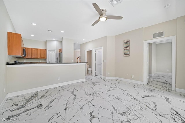 unfurnished living room featuring ceiling fan