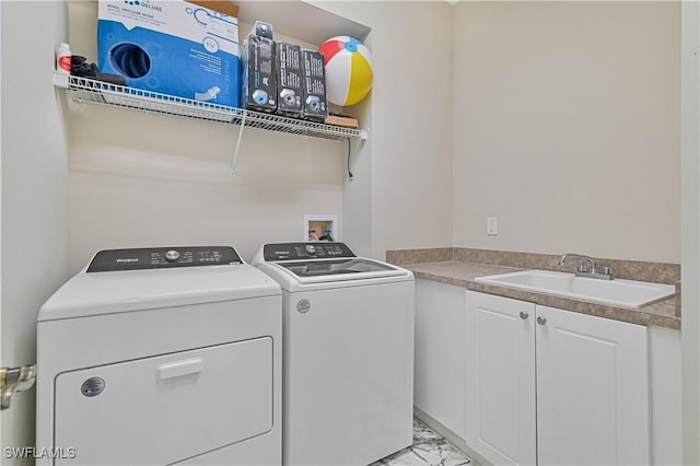 laundry room with cabinets, separate washer and dryer, and sink