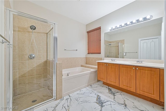 bathroom featuring vanity and independent shower and bath