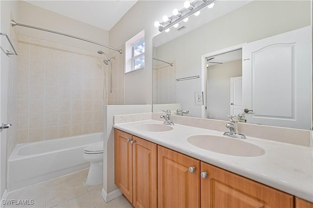 full bathroom with tile patterned flooring, vanity, toilet, and tiled shower / bath