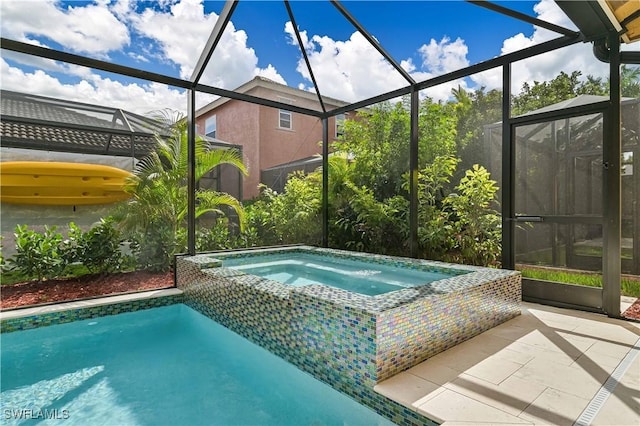 view of pool featuring an in ground hot tub, a lanai, and a patio area