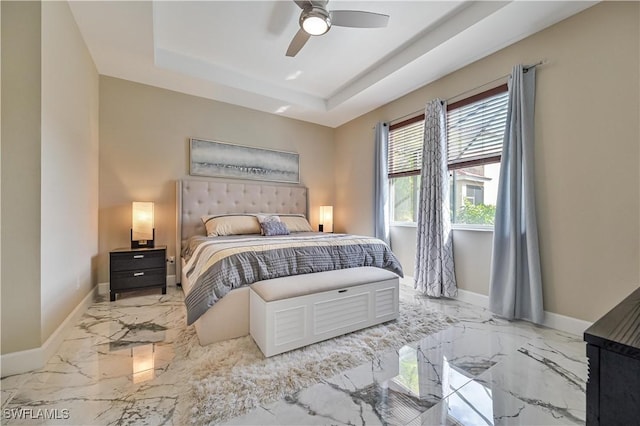 bedroom featuring ceiling fan and a raised ceiling