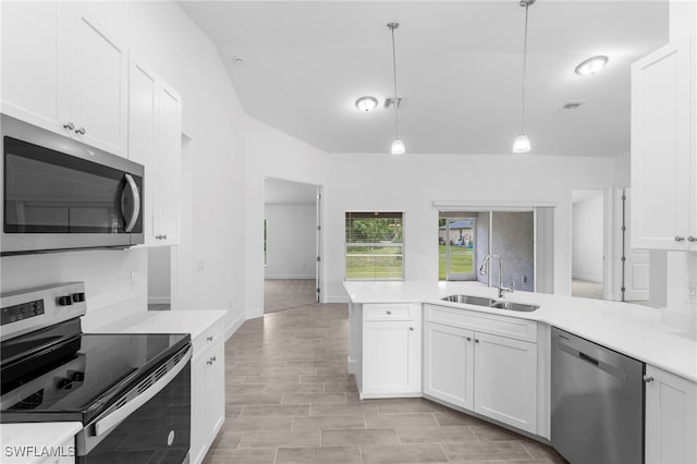 kitchen featuring white cabinetry, sink, decorative light fixtures, and stainless steel appliances