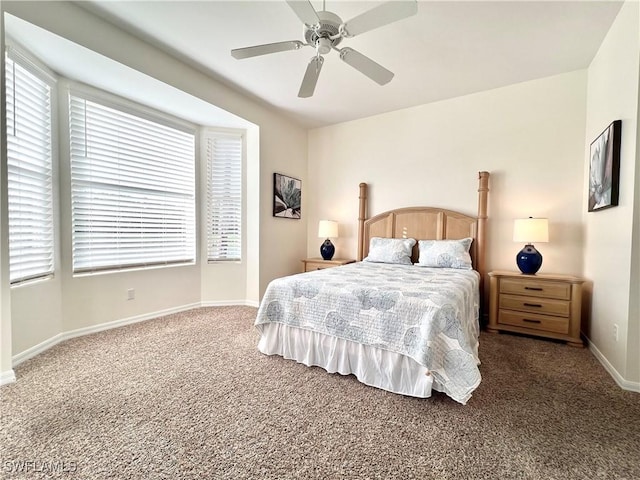 bedroom featuring ceiling fan, dark carpet, and baseboards