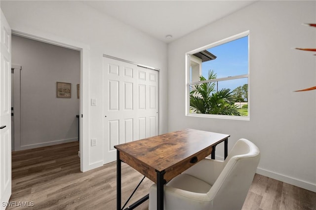 home office with hardwood / wood-style flooring