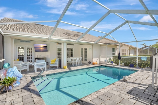 view of pool with a patio area, french doors, and glass enclosure