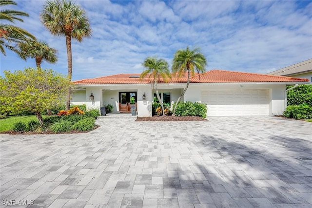 mediterranean / spanish house with a garage