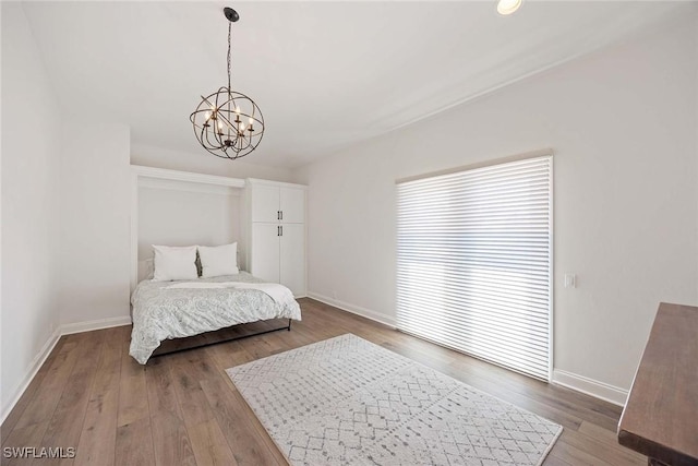 4611 Crayton Rd, Naples, FL 34103 - bedroom featuring baseboards, a chandelier, and hardwood / wood-style floors