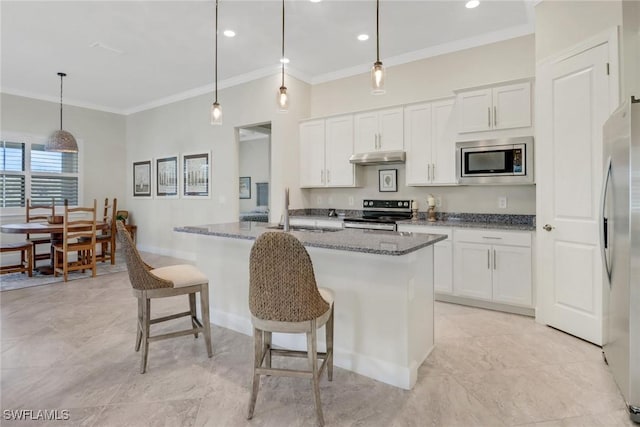 kitchen with appliances with stainless steel finishes, decorative light fixtures, white cabinets, and dark stone counters