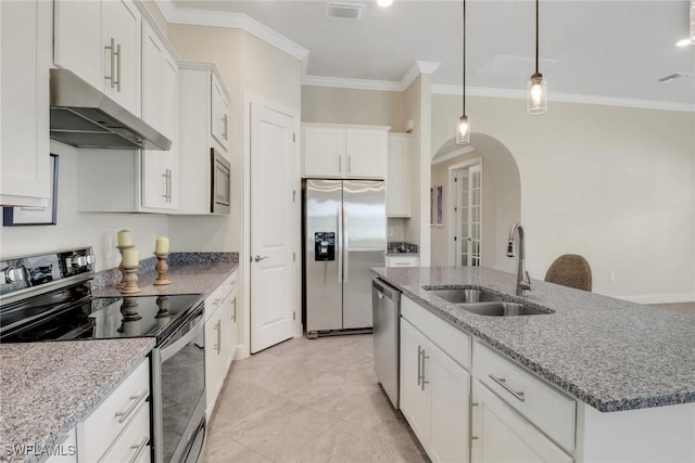 kitchen with appliances with stainless steel finishes, sink, a center island with sink, and white cabinets