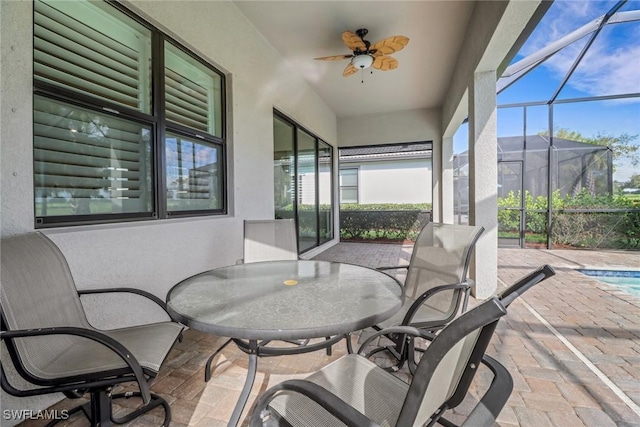 sunroom / solarium featuring plenty of natural light and ceiling fan