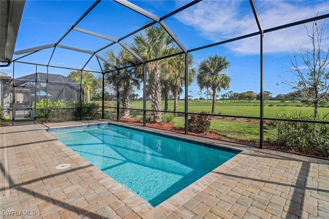 view of pool with a lanai and a patio