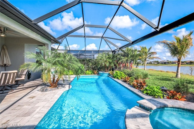 pool featuring a water view, glass enclosure, a ceiling fan, and a patio