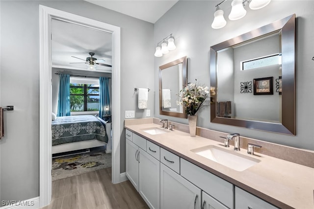 full bath featuring connected bathroom, a sink, ceiling fan, and double vanity