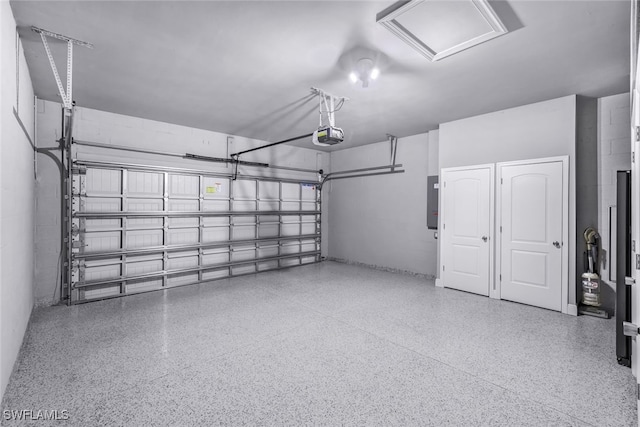 garage with a garage door opener and electric panel