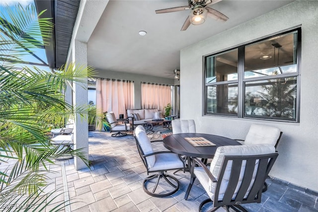 view of patio with an outdoor hangout area, outdoor dining area, and a ceiling fan