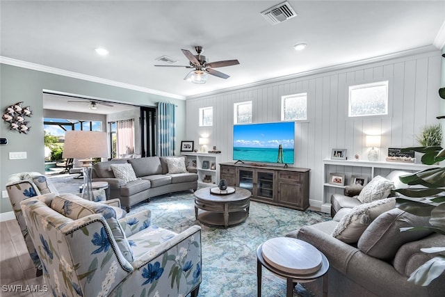 living room featuring ceiling fan, visible vents, and ornamental molding