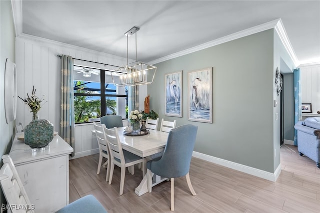 dining space featuring ornamental molding, wood tiled floor, a notable chandelier, and baseboards