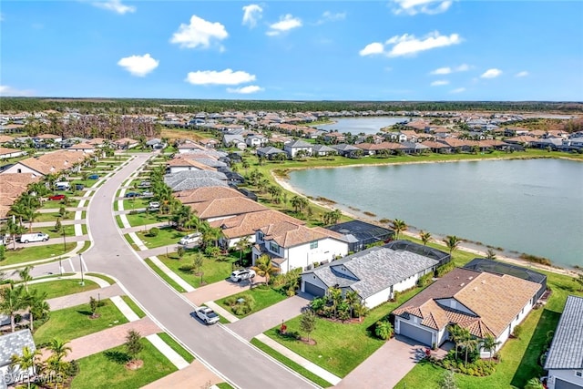 drone / aerial view with a water view and a residential view