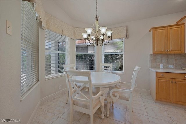 tiled dining space with an inviting chandelier