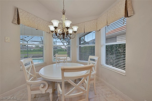 dining space featuring an inviting chandelier and light tile patterned floors