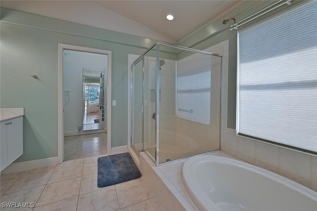 bathroom featuring lofted ceiling, vanity, tile patterned flooring, and plus walk in shower