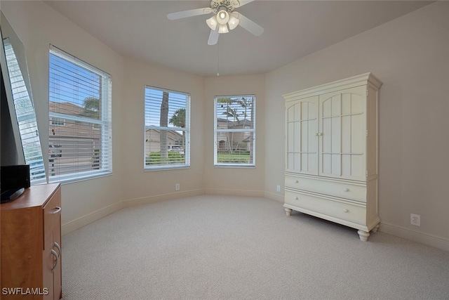 unfurnished bedroom with light carpet and ceiling fan