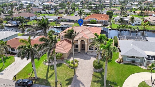 drone / aerial view with a water view and a residential view