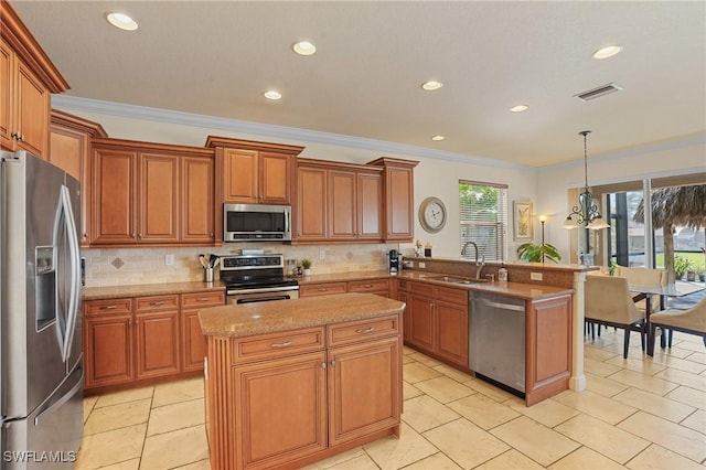 kitchen with visible vents, appliances with stainless steel finishes, a sink, light stone countertops, and a peninsula