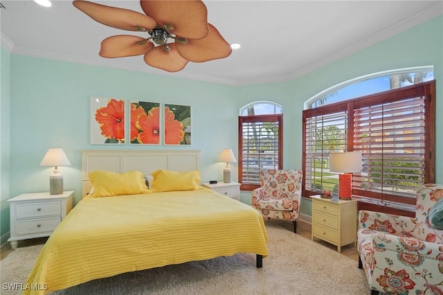 carpeted bedroom featuring ceiling fan and ornamental molding