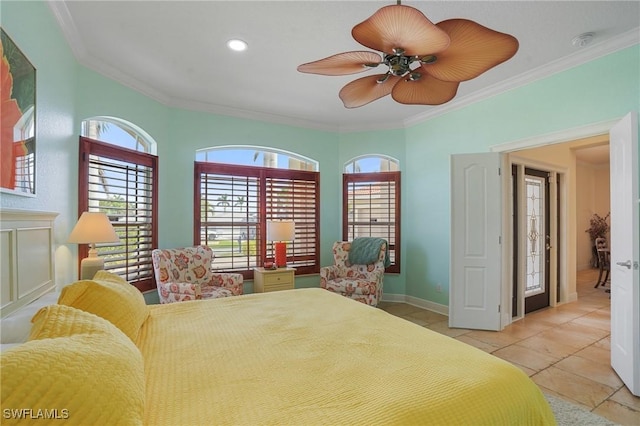 bedroom with baseboards, ornamental molding, a ceiling fan, and tile patterned floors