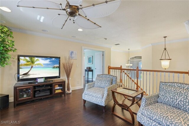 sitting room with baseboards, crown molding, an upstairs landing, and wood finished floors