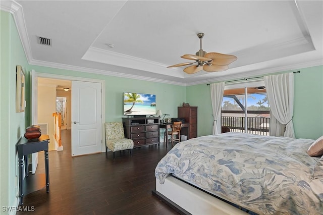 bedroom with visible vents, a raised ceiling, ornamental molding, dark wood-type flooring, and access to outside